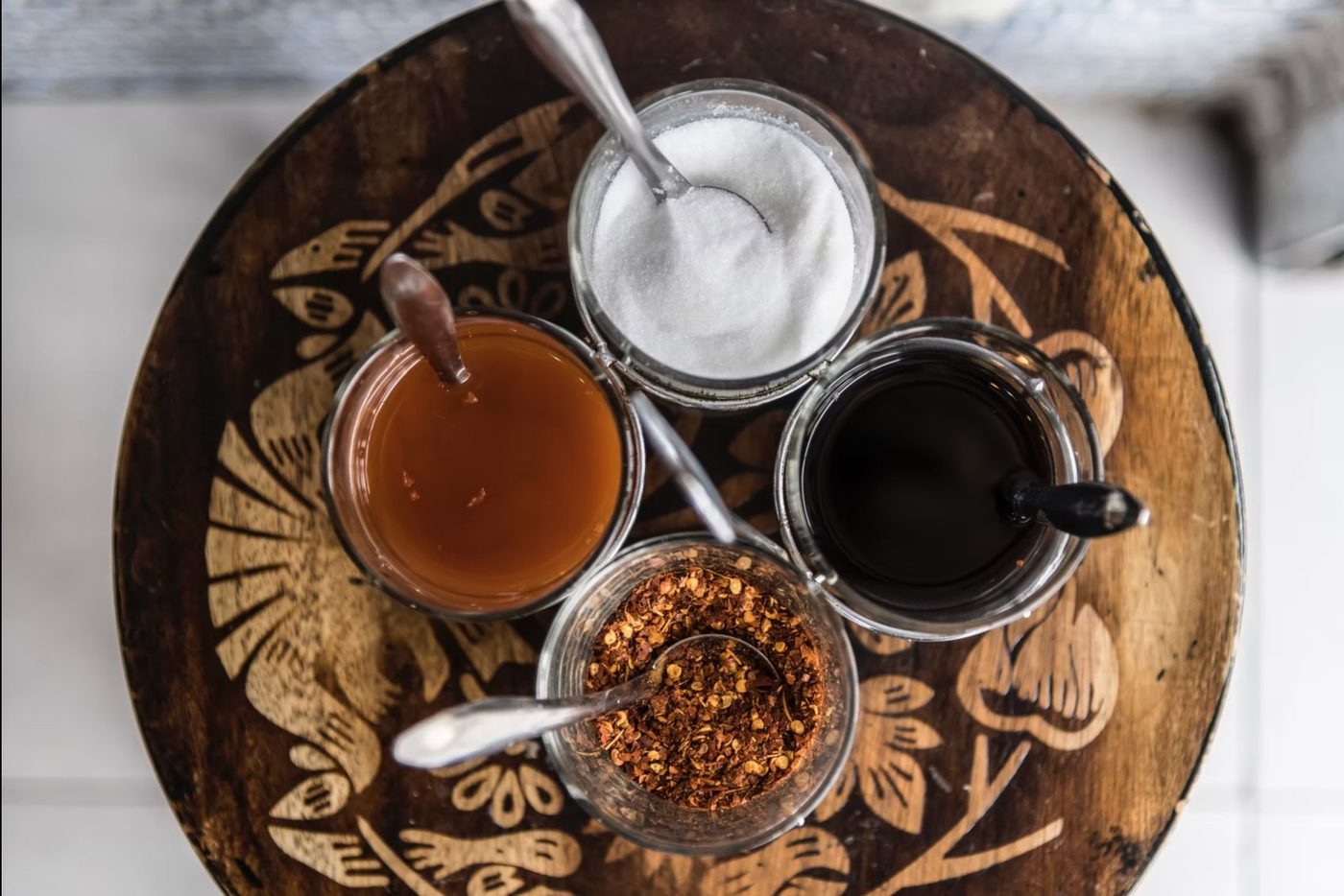 The four Thai condiments: sugar, fish sauce, vinegar, chili flakes